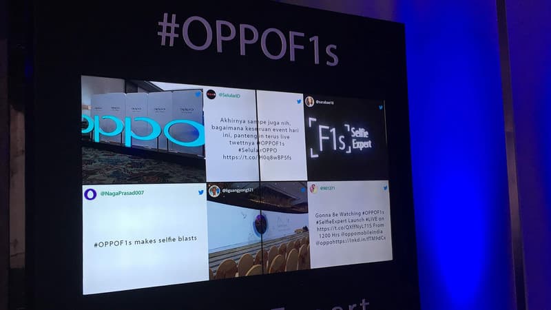Digital displays in a venue showcasing event updates and social conversations